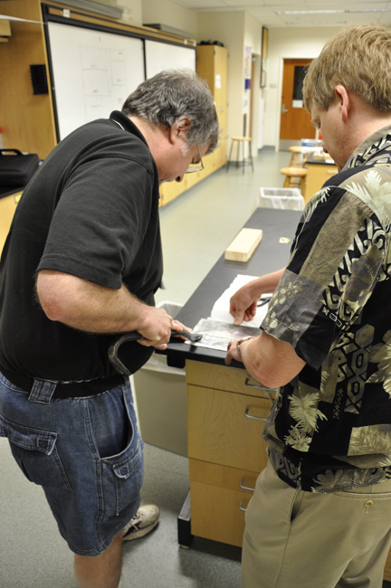Mike Epstein and Dwight Tshudy prepare exemplar toolmarks of a crowbar 